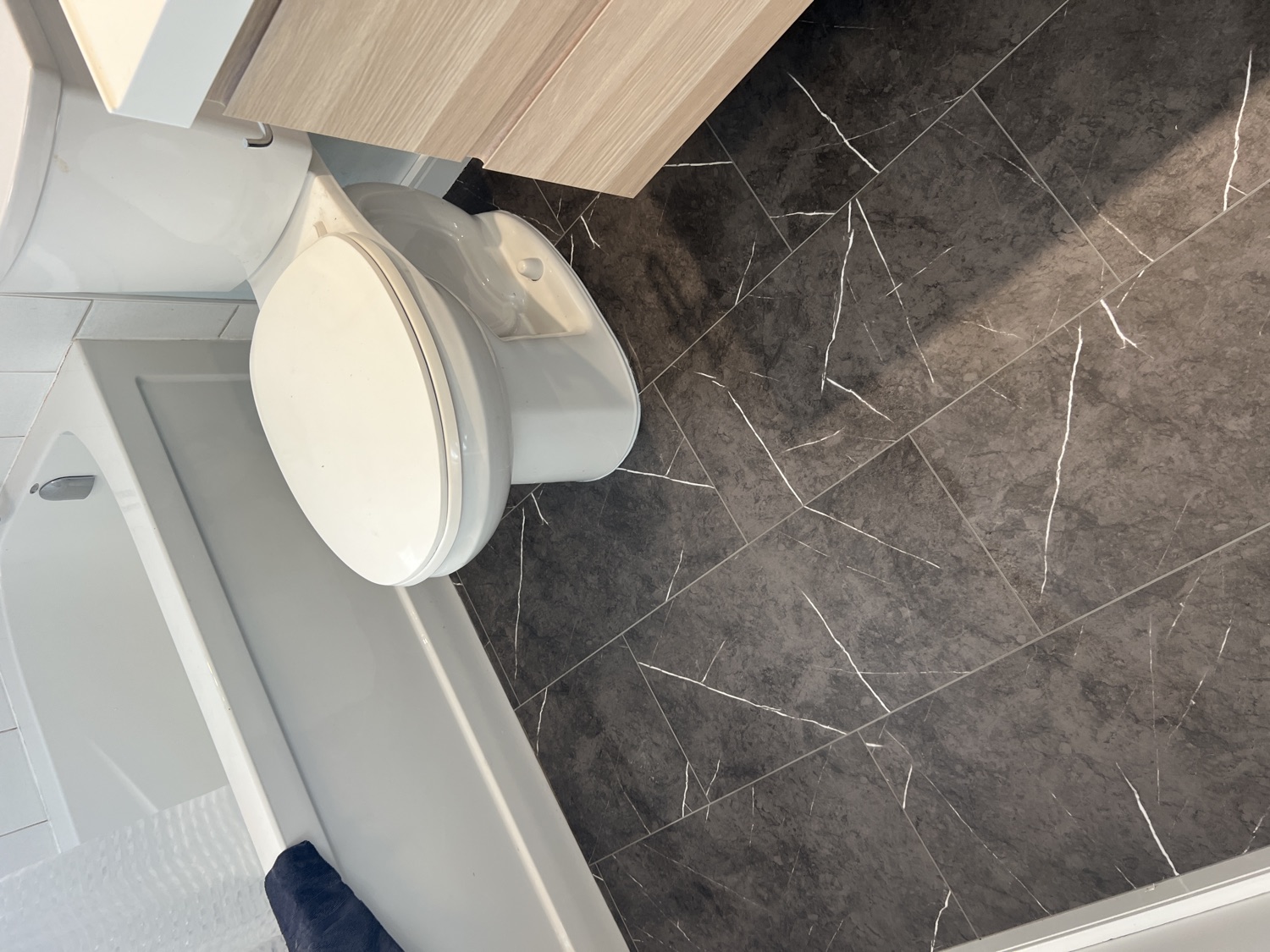 Bathroom taken from bare subfloor to finished tile — After